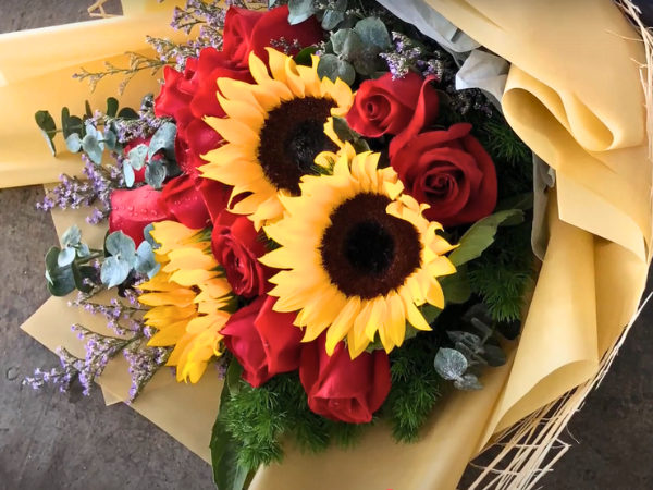 The Unique Beauty Of Sunflowers And Red Roses Together photo